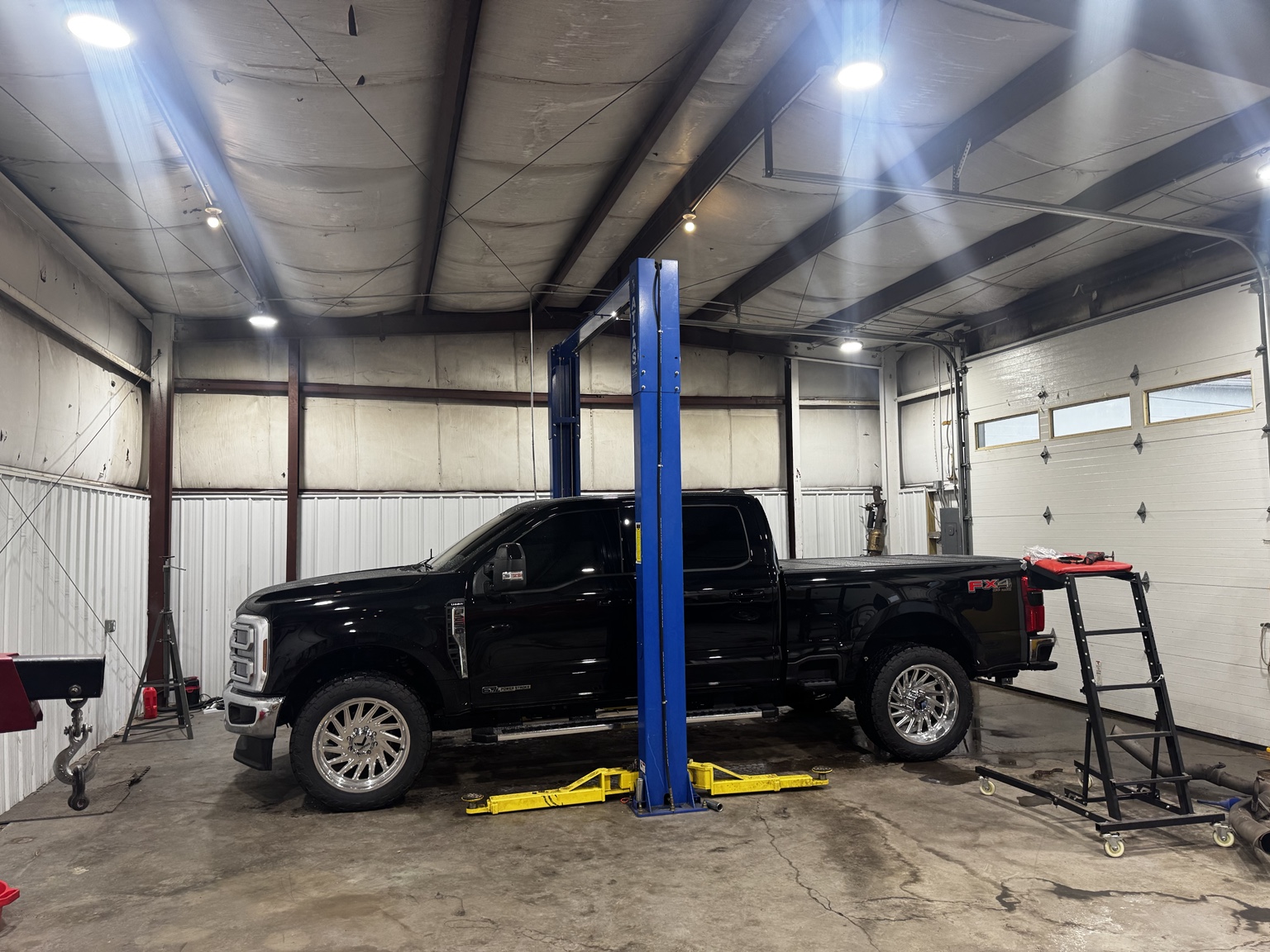 Diesel pickup inside Triple G Automotive service bay